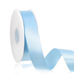 light blue satin ribbon on white background with reflection in the floor and one side rolled up