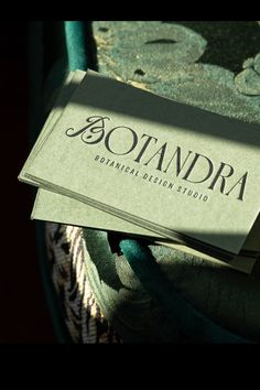 a business card sitting on top of a chair with the word botandra printed on it