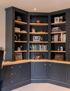 an office with built in bookshelves and desk