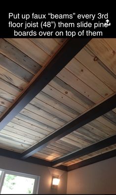 the inside of a room with wood planks on the ceiling