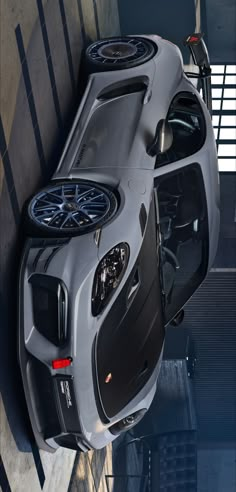 the top view of a car with its doors open in a parking garage, taken from above