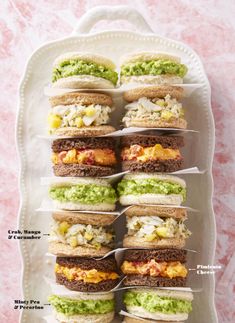 several sandwiches are stacked on top of each other with different toppings in the middle