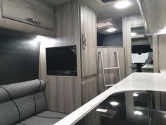 the interior of an rv with white counter tops