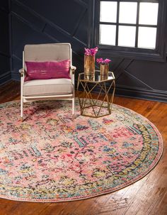 a living room with a chair, table and rug