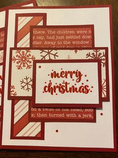 three christmas cards with the words merry christmas written in red and white on them, sitting on a table