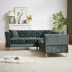 a living room scene with focus on the sectional sofa and rug, which is placed in front of a fireplace