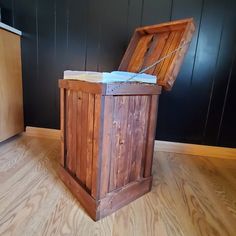 a wooden box sitting on top of a hard wood floor