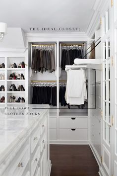 a walk in closet with white cabinets and drawers