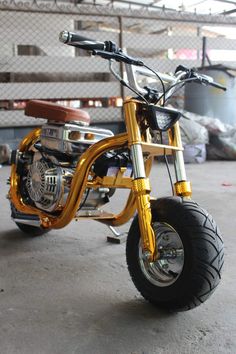 a gold motorcycle parked inside of a garage