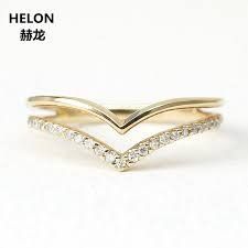 a yellow gold ring with white diamonds on the bottom and an open chevron band