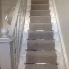 a set of stairs with carpet on the bottom and handrails to the top