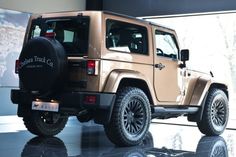 a jeep is parked in front of a large window