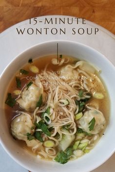 a white bowl filled with soup on top of a wooden table