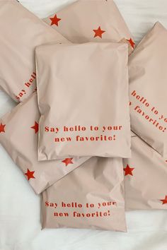 four bags with red stars on them that say hello to your new favorite, say hello to your new favorite