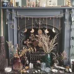 a fireplace decorated with dried plants and decorations