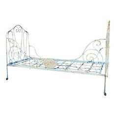 a metal bed frame with an ornate design