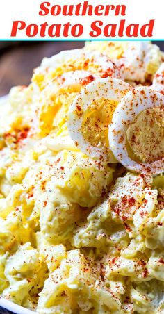 a bowl filled with potato salad topped with hard boiled eggs and parmesan cheese