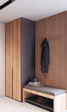 a wooden bench sitting next to a coat rack