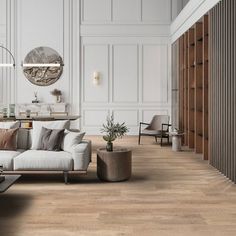 a living room filled with lots of furniture and wooden flooring covered in white walls