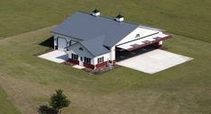 an aerial view of a house in the middle of a field