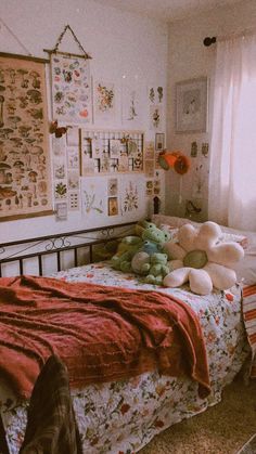 there is a bed with two teddy bears on it and many pictures above the bed