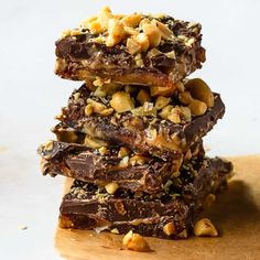 three chocolate bars stacked on top of each other with nuts and walnuts in the middle