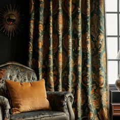 a chair and lamp in front of a window with curtains on the windowsills