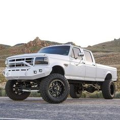 a white truck parked on the side of a road