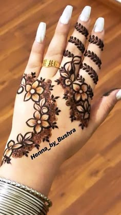 hendi designs for hands and fingers with flowers on the palm, which is decorated with gold