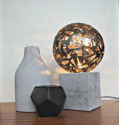 a light that is on top of a table next to a vase and a lamp