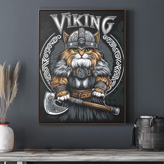 a cat wearing a viking helmet and holding two axes in front of a gray wall