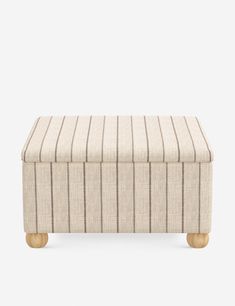 a beige and black striped ottoman with wooden legs, on a white background the foot rest is upholstered