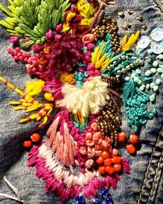 an assortment of colorful beads and buttons on a pair of jeans