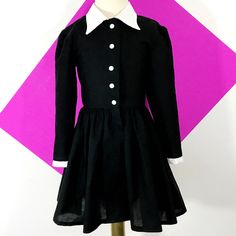 This is an adorable black shirt dress with a full skirt. I could also make it out of different fabrics, if you are looking for a custom shirt dress, message me for customization. accessories not included. This dress is perfect for Halloween Thank you for checking out my listing! Preppy Long Sleeve Dresses For Fall, Fitted Doll Collar Dress For School, Black Peter Pan Collar Dress For Fall, Black Fall Dress With Peter Pan Collar, Fall Costume Party Dress With Doll Collar, Black School Dresses For Fall, Cute Long Sleeve Costume Dress, Formal Fall Dress With Peter Pan Collar, Long Sleeve Cotton School Dress