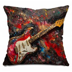 a red and black guitar pillow on a white background with colorful paint splatters