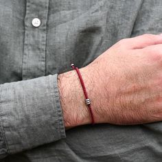 Introducing the "Iron Flow" bracelet – a symbol of strength and protection. Handcrafted in the UK, this vibrant red cord bracelet adorned with steel beads is the perfect iron 6th anniversary gift, embodying durability and resilience.  The bold red cord adds a striking touch, while the steel beads, known for their protective properties, make this bracelet more than just an accessory; it's a shield against life's trials, offering both physical and emotional fortitude. Celebrate your enduring love with a piece that signifies unwavering strength and steadfast protection. Effortless Maintenance: No Care Needed. The more you wear it, the cooler it gets. Just keep it away from chemicals for lasting durability. Red Cord Bracelet, Iron Anniversary Gifts, 6th Anniversary Gifts, Red Rope, Red Bracelets, August Birthstone Jewelry, July Birthstone Jewelry, Unique Bracelets, Diy Crafts Jewelry