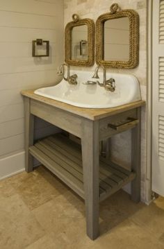 a bathroom sink with two mirrors on the wall and a shelf below it for storage