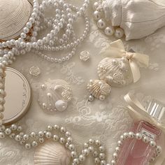 shells, pearls and perfume bottles on a lace tablecloth