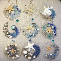 six glass ornaments with starfish and seashells on them