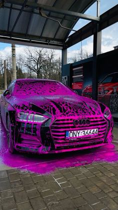 a car covered in purple paint on the street