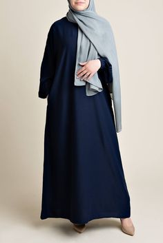 Model wearing a classic Abaya with side pockets in a navy blue color - Front pose - Momina Hijabs Color Abaya Design, Navy Blue Abaya, Straight Abaya, Everyday Abaya, Blue Abaya, Modest Woman, Hijab Colors, Abaya Outfit, Muslimah Outfit