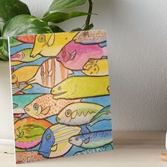 a painting of many different colored fish art board print