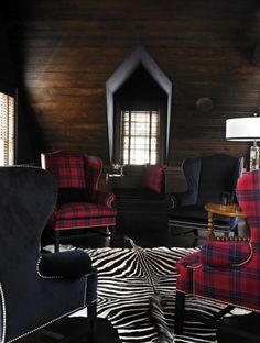 a living room filled with furniture and a zebra print rug