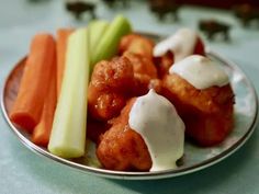 a plate full of food with carrots and celery