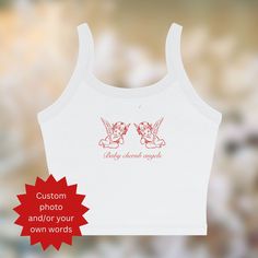 ⭐This Baby Cherub Angels spaghetti strap tank top features two adorable cherub angels and a playful graphic text. Perfect for adding a sweet, Y2K-inspired touch to your summer wardrobe or for layering during cooler months. Soft and lightweight, it's ideal for festivals, casual wear, or channeling retro 90s vibes. A charming and versatile piece for flirty, fun fashion lovers! Follow and tag us on Instagram for a discount code 📸.  Please message me when you tag me   ⭐Some images are created with Angel Graphic, Spaghetti Strap Shirt, Graphic Y2k, Cute Angel, Aesthetic 90s, 90s Baby, 90s Vibes, Baby Tees, Spaghetti Strap Tank Top