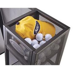 a yellow hat and some golf balls in a mesh container