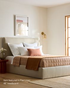 a bed sitting in a bedroom on top of a wooden floor next to a window