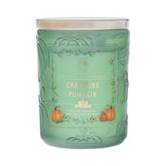 a green glass jar with pumpkins on the lid and label that says charming pumpkin