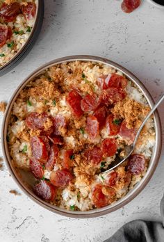 two bowls filled with rice and meat on top of a white table next to a cup of coffee