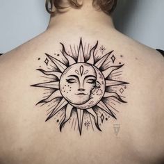 the back of a woman's shoulder with a sun and moon tattoo on it